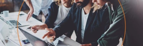 A design team collaborates on a laptop