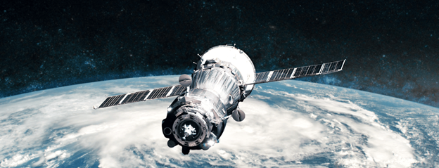 A high-resolution image of a satellite in Earth's orbit, with solar panels extended and various antennae visible.